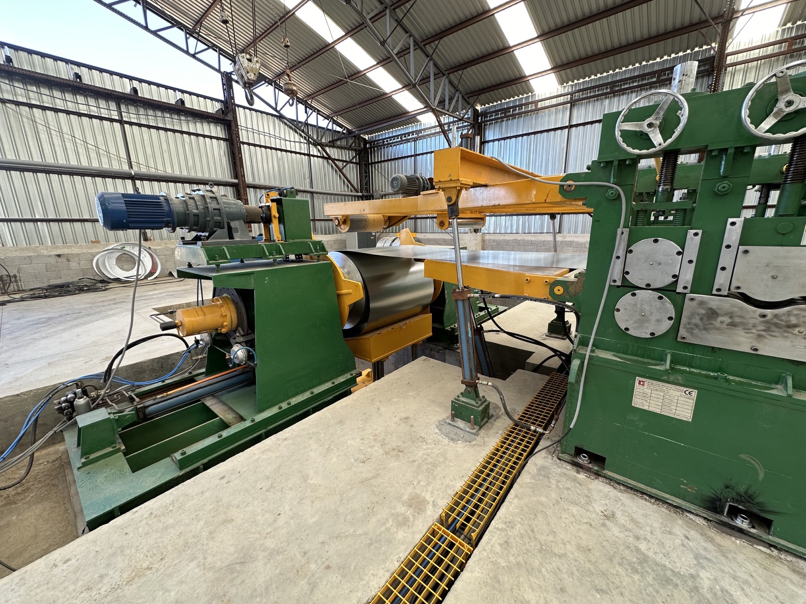 Master steel coils and the slitting line on the Cal Steel production floor.