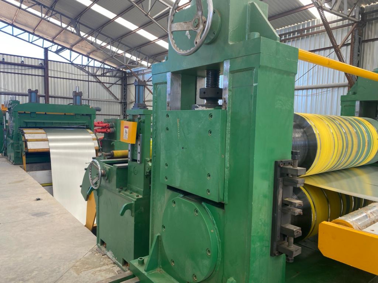 Master steel coils and the slitting line on the Cal Steel production floor.