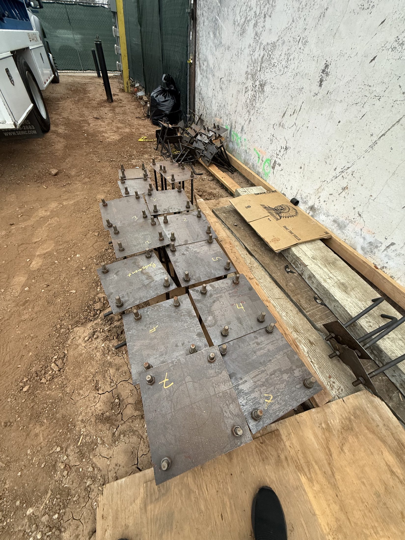 Fabricated structural steel embed plates staged on site at 777 Ocampo