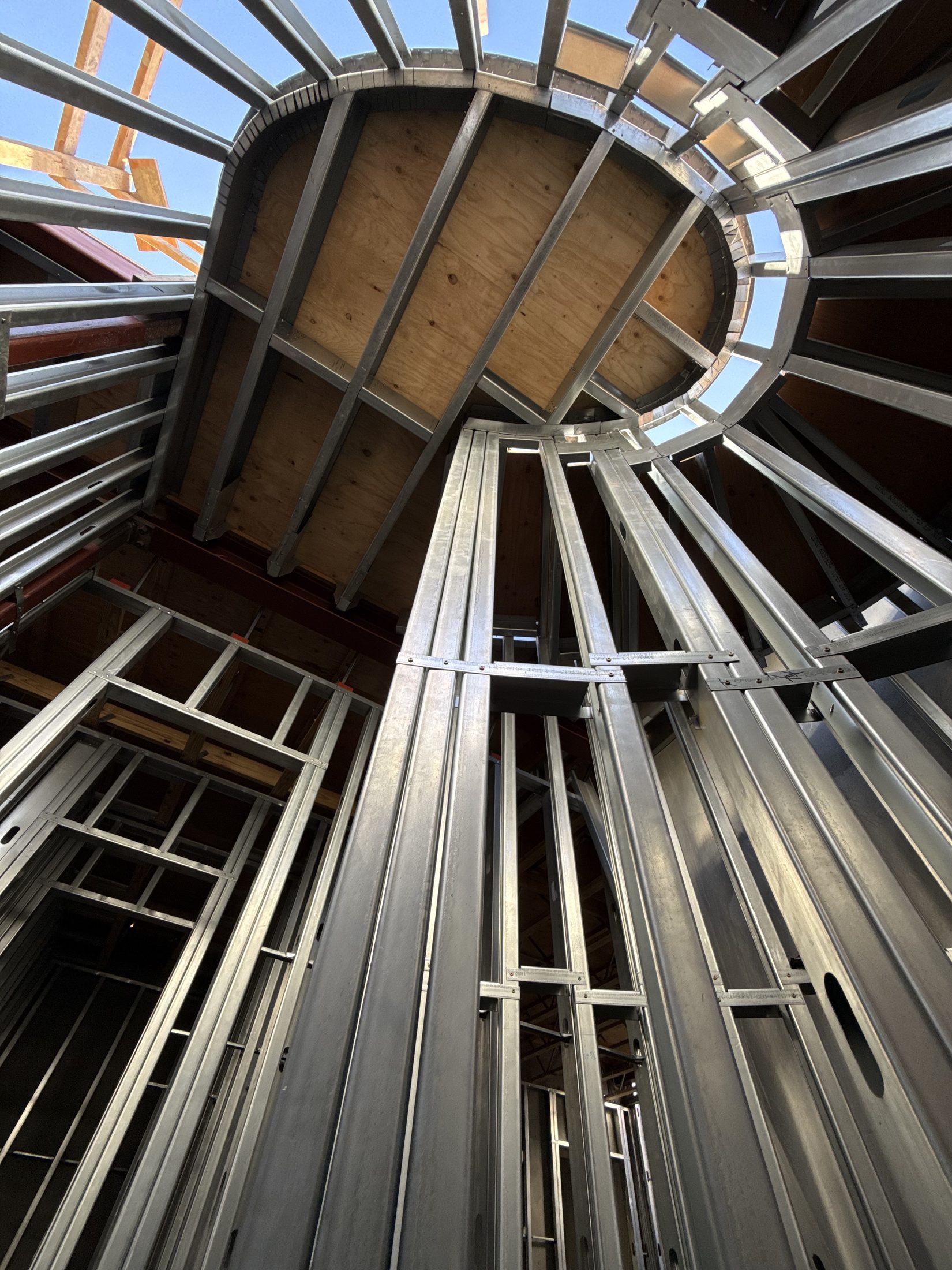 Looking straight up inside the curved steel stair drum at 777 Ocampo