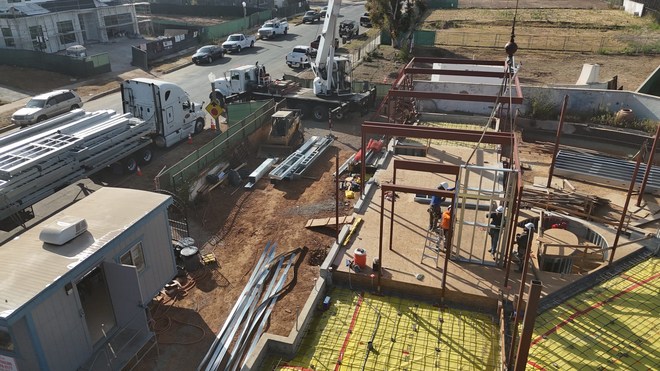 Aerial close-in of the structural steel frame and crew at 777 Ocampo
