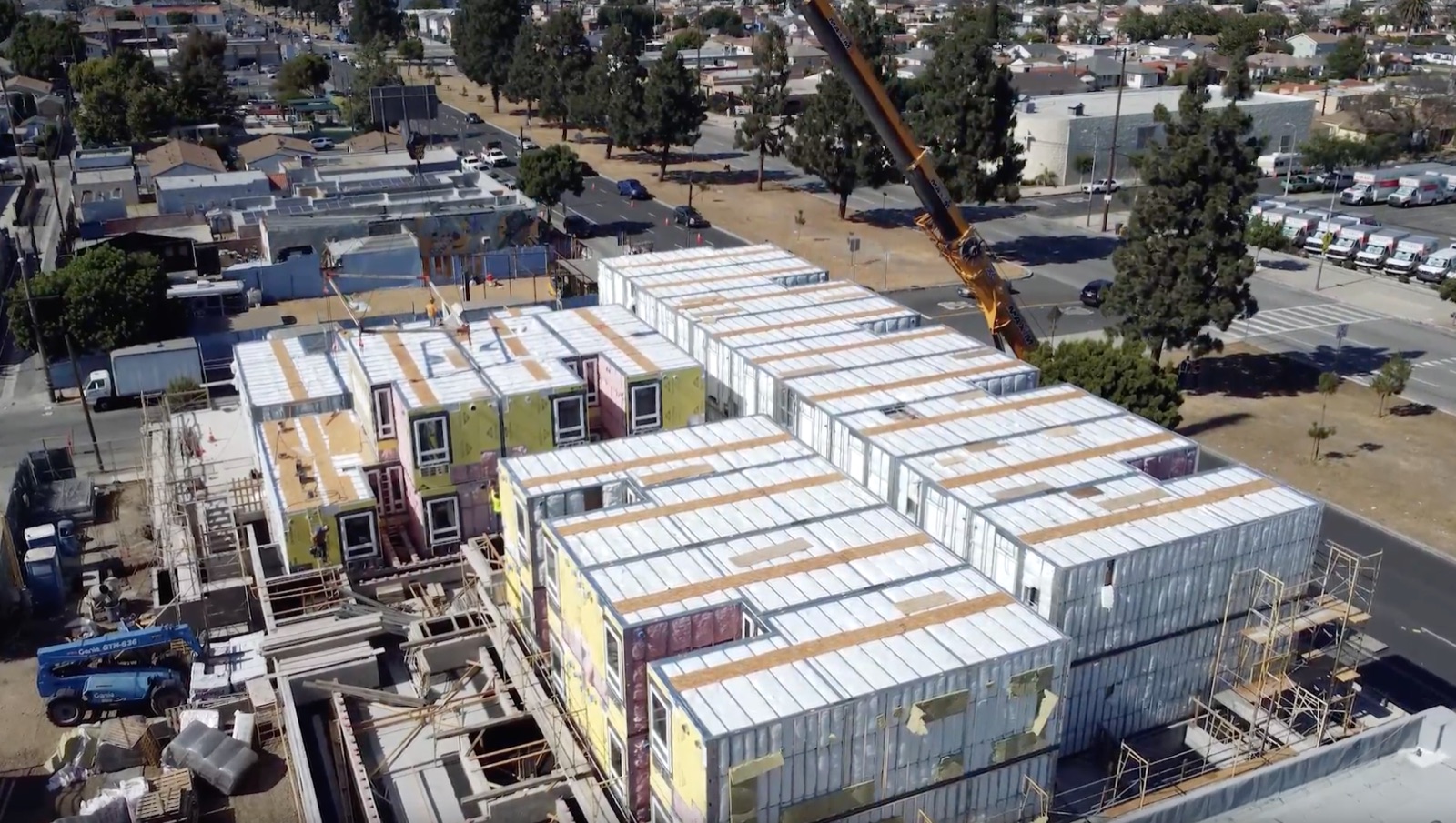 Volumetric modules set into a U-shaped building over the podium