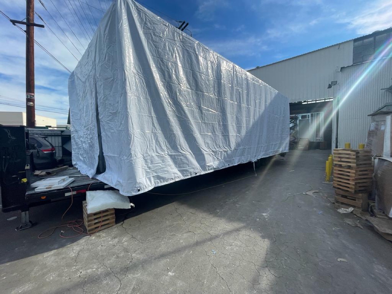 A wrapped volumetric module loaded for transport to the site